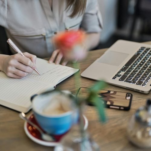 Home office with a desk, laptop and a cup of coffee